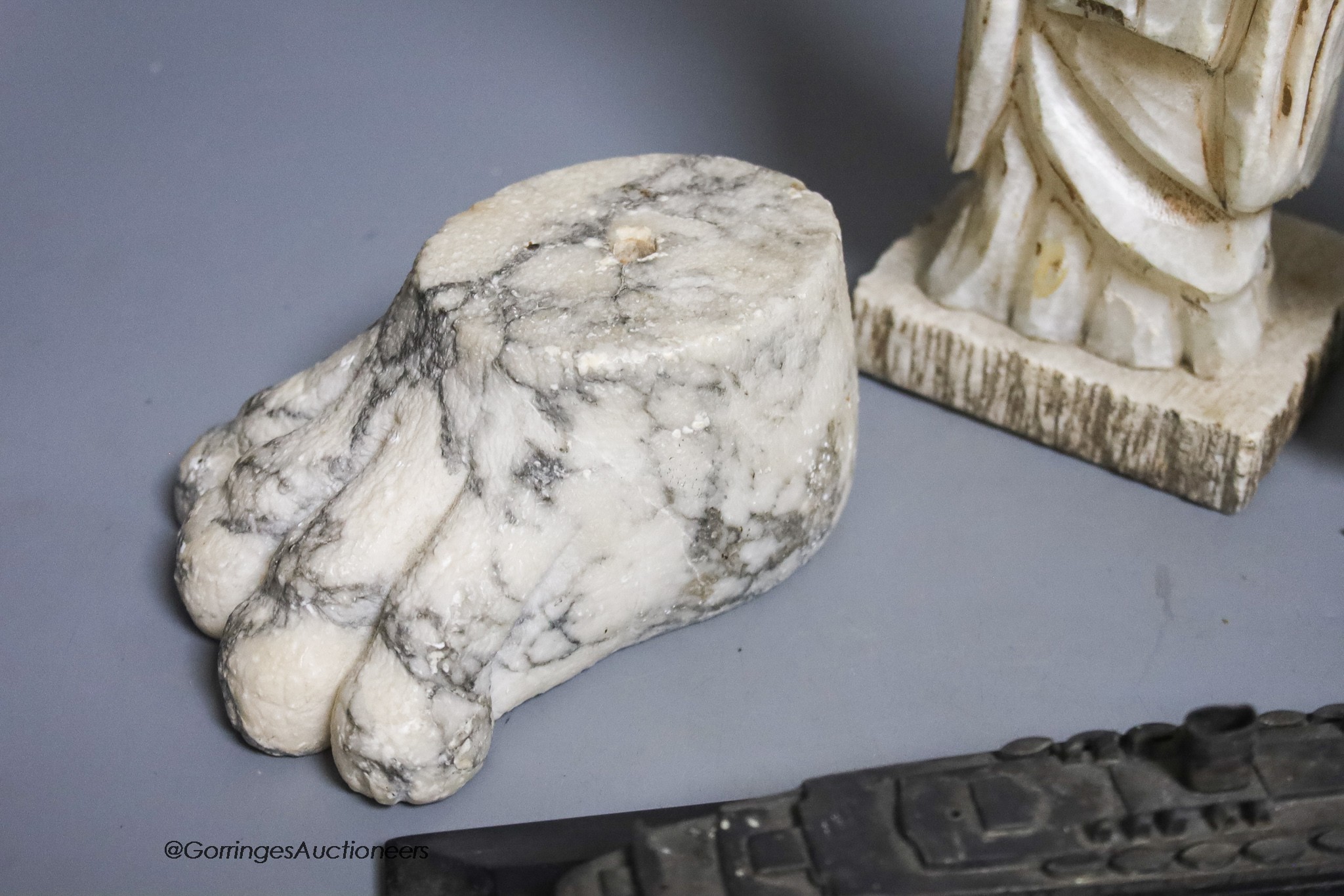 A large marble lion's paw, an alabaster monk, a soapstone crane and a white metal model of The Queen Mary ship